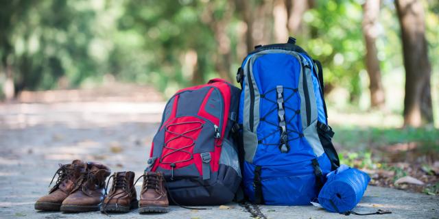 vecteezy_backpack-and-shoes-backpackers-rest-on-the-road-while-go-hiking_3094632.jpg